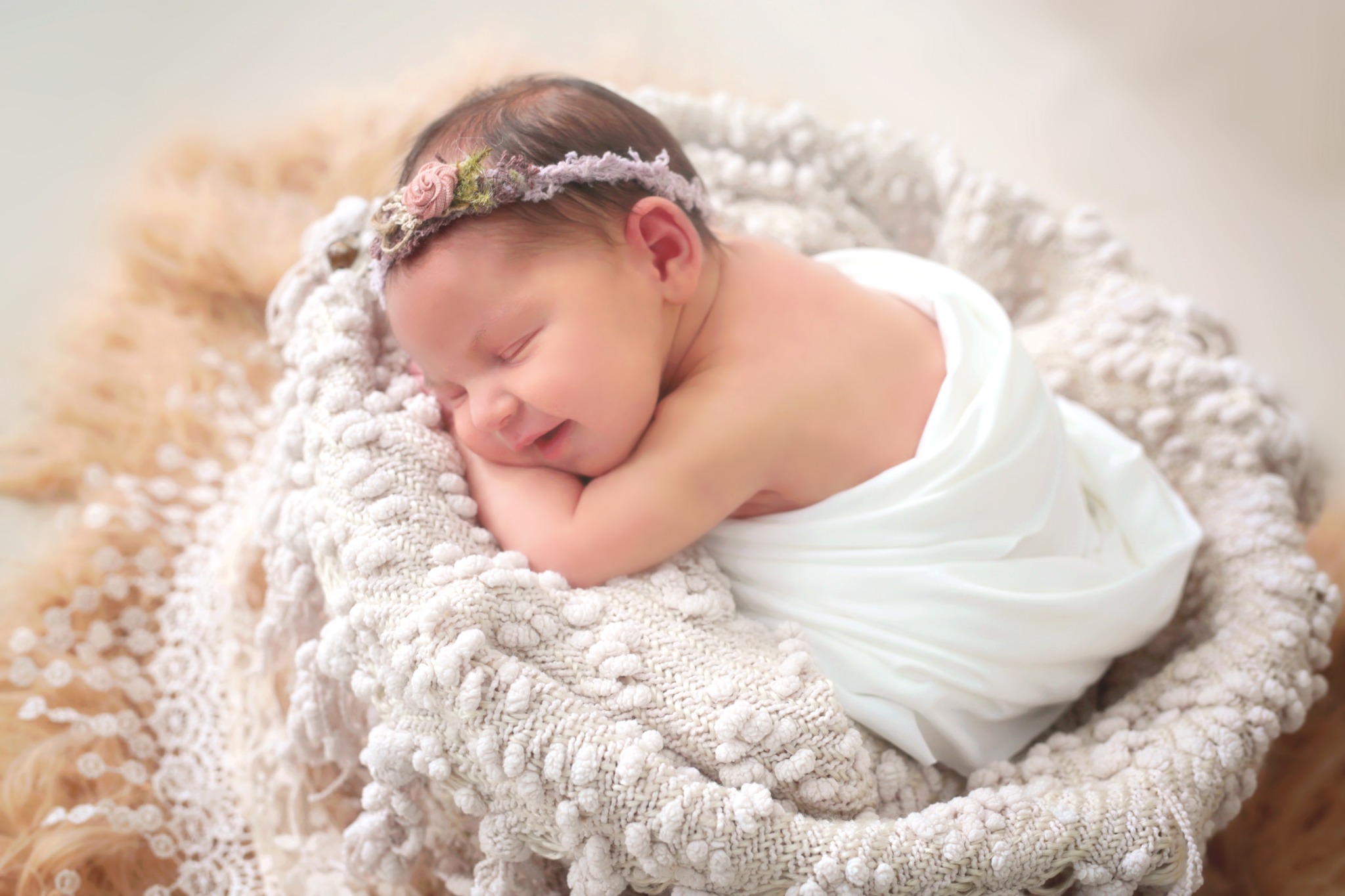 Sleeping newborn with a floral headband